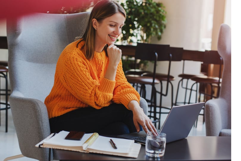woman using laptop in a common space at the office